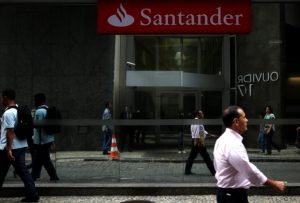 People walk past a Banco Santander branch in downtown Rio de Janeiro